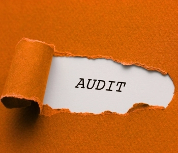 Un papier orange, style construction, déchiré. On peut lire dessous le mot audit pour le service d'audit SEO de Ly Rédaction.